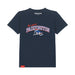 A navy blue short-sleeve t-shirt with a 'Be more PADDINGTON' graphic on the chest, featuring a bear on a deckchair illustration and a red Paddington brand tag near the bottom hem, shown on a plain white background.
