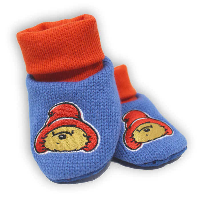 Pair of blue baby shoes with red cuffs and Paddington cartoon character on a white background
