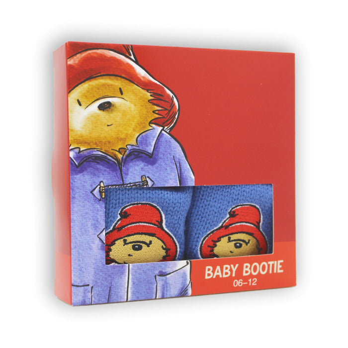 Box of Paddington Bear baby booties with red hat design on a white background
