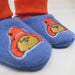 Blue Paddington slippers with cartoon character design worn by a person in orange socks.