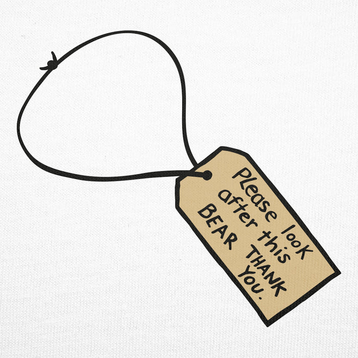 Close up paddington luggage tag emblem saying please look after this bear