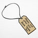 Close up paddington luggage tag emblem saying please look after this bear