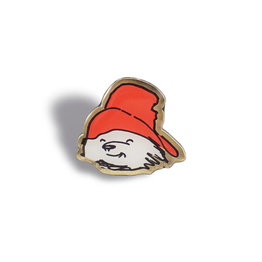 Pin with a cartoonish character wearing a red hat on a white background