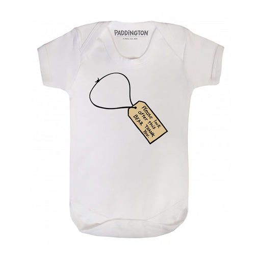 White short sleeve baby bodysuit with a charm design resembling a luggage tag featuring the Paddington Bear figure.
