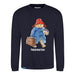 A navy blue sweatshirt with a graphic print of Paddington Bear wearing a red hat and blue coat, holding a suitcase, and the name 'Paddington' written across the bottom.