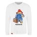 A white sweatshirt with a graphic print of Paddington Bear wearing a red hat and blue coat, holding a suitcase, and the name 'Paddington' written across the bottom.