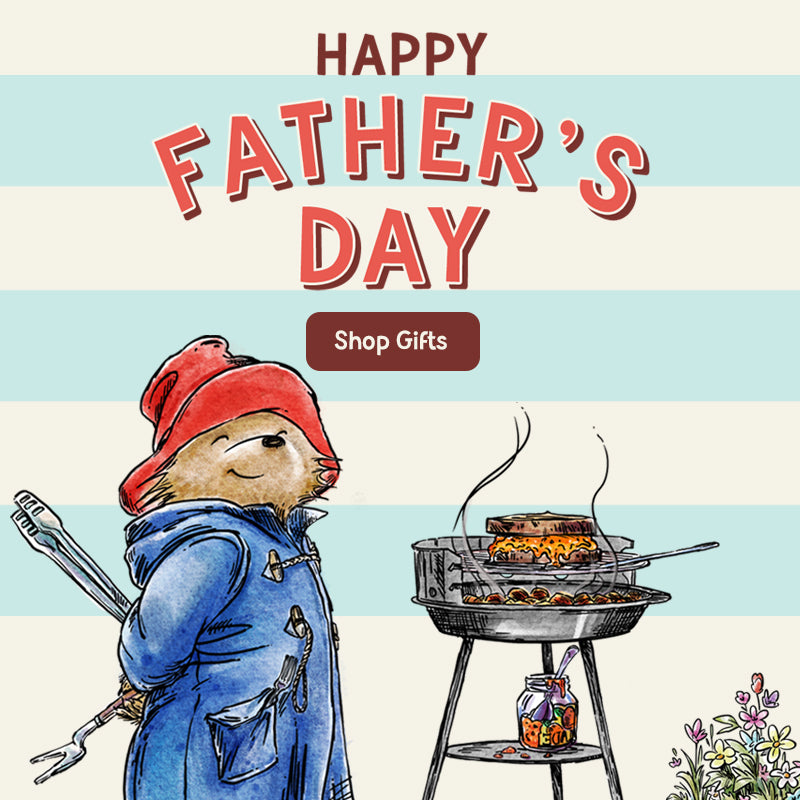Paddington bear in overalls grilling with 'Happy Father's Day' text and gift shop callout.