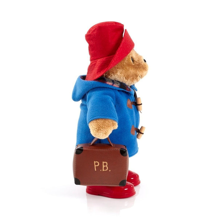Paddington Bear with a suitcase on a white background