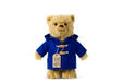 Paddington Teddy bear wearing a blue coat with a label on a white background
