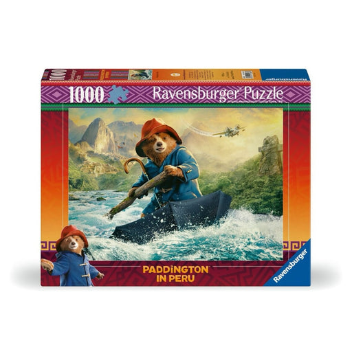 Jigsaw with Paddington bear character in a blue coat and red hat rowing a boat through a river with mountains and a helicopter in the background.