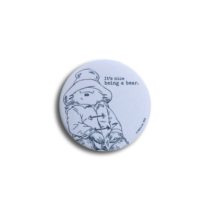 Blue button badge with Paddington bear illustration and text 'It's nice being a bear' on a white background