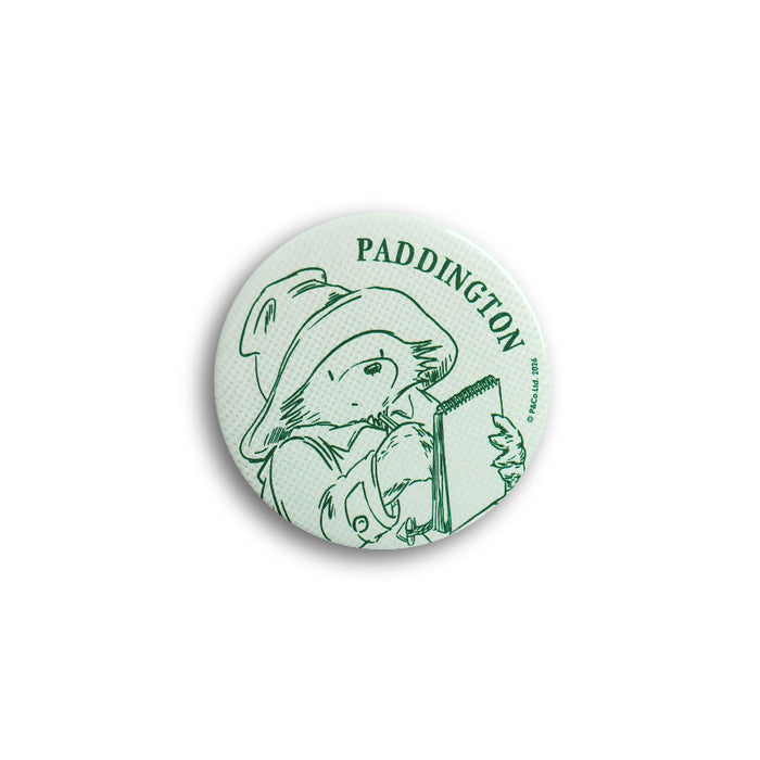 Green button badge with Paddington Bear design on a white background