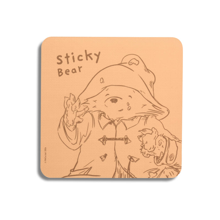 A orange Paddington coffee table coaster with sketch and quote