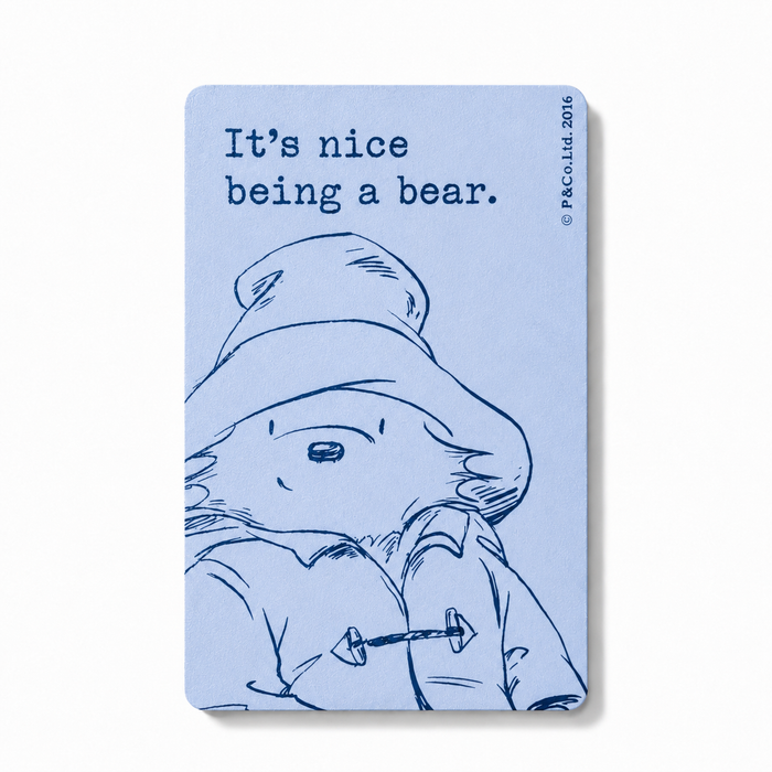 Magnet with a bear illustration and text on a light blue background