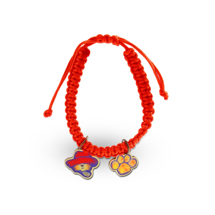 Red braided bracelet with a blue and purple paw print charm on a white background