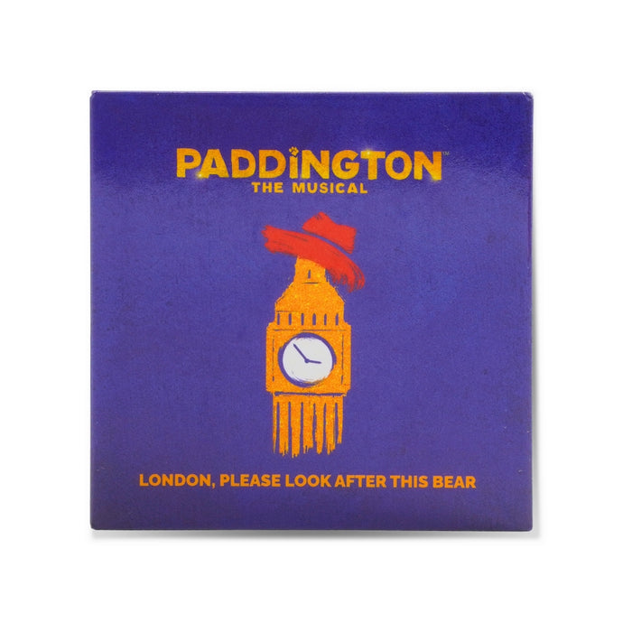 Square purple magnet with 'Paddington The Musical' text and illustration of big ben wearing a red hat on a white background