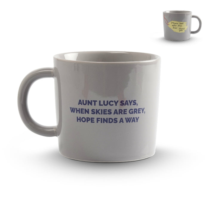 Gray mug with text 'Aunt Lucy says, When skies are grey, hope finds a way' on a white background