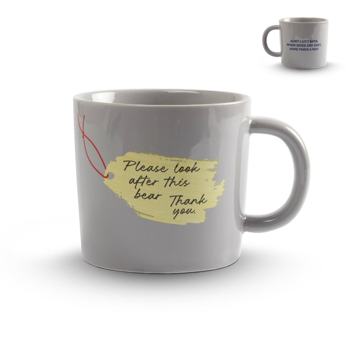 Gray mug with a yellow tag and text on a white background