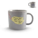 Gray mug with a yellow tag and text on a white background