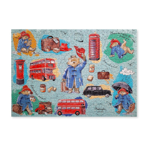 Jigsaw puzzle with Paddington Bear and London-themed pieces on a white background