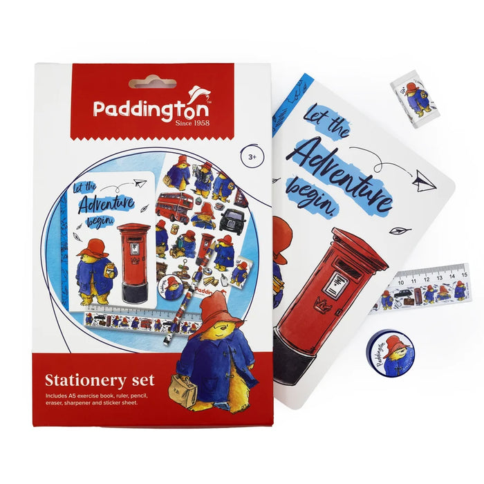 Paddington stationery set with a white and red box, a printed booklet, a ruler, a sticker, and a packaging featuring Paddington Bear illustrations and text on a white background.