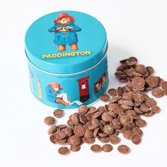 Blue tin with Paddington Bear design, filled with chocolate buttons on a white background