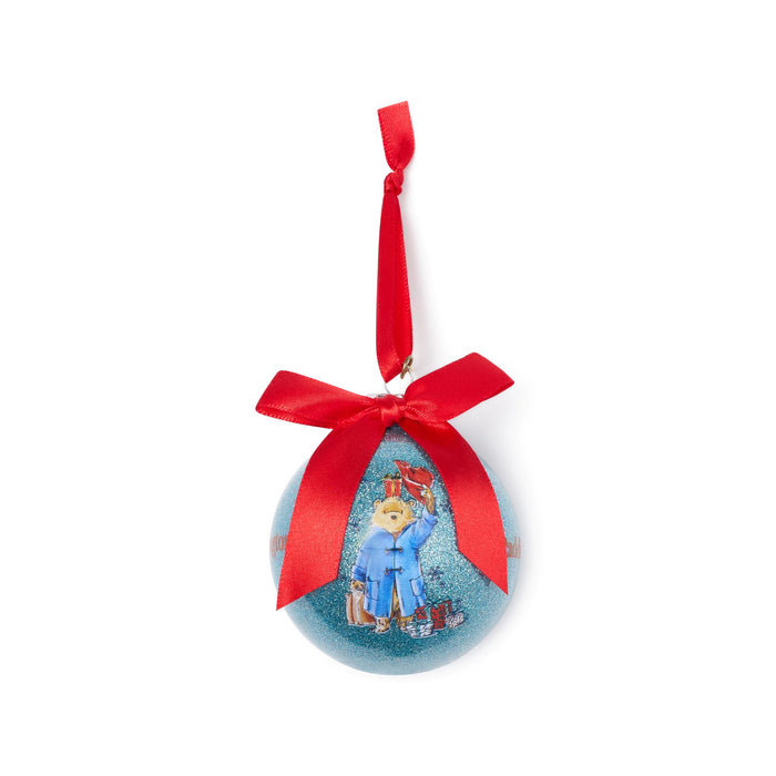 Decorative blue Paddington Christmas ball ornament with a red ribbon on a white background