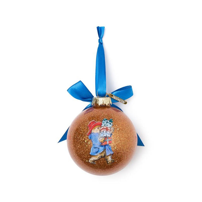Orange Christmas ornament with a Paddington bear design, a blue ribbon on a white background