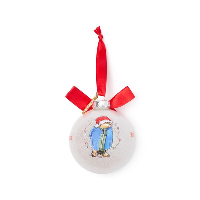 Pink Christmas ornament with a Paddington bear design and red ribbon on a white background