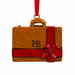 Decorative suitcase ornament with red ribbon and 'PB' initials on a white background