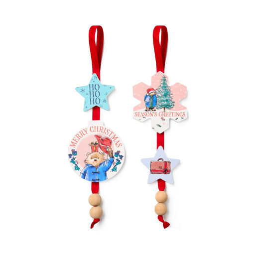 Set of Christmas-themed Paddington decorative ornaments with red ribbons on a white background