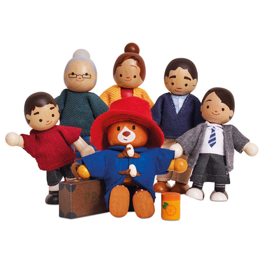 A set of wooden family and Paddington Bear figures with fabric clothing and accessories, including a central figure in a red hat and coat, surrounded by six other wooden dolls house characters on a plain white background.