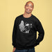 Man wearing a black Halloween Paddington bear sweatshirt with a graphic design on a yellow background
