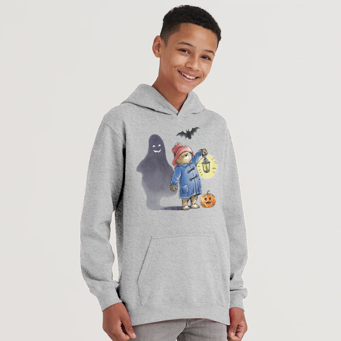 Child wearing a gray Paddington bear hoodie with a Halloween-themed design on a light gray background