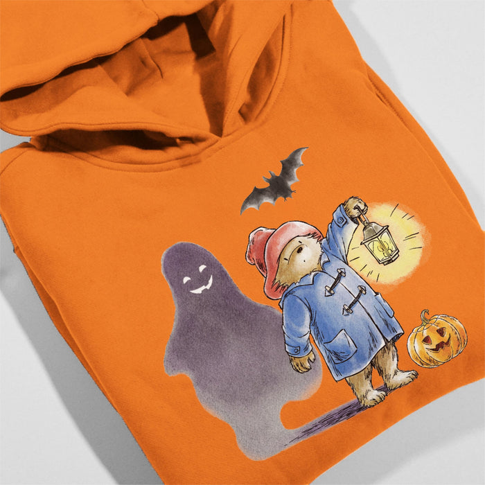 Orange hoodie with Halloween-themed design featuring a ghost, Paddington bear, and pumpkin.