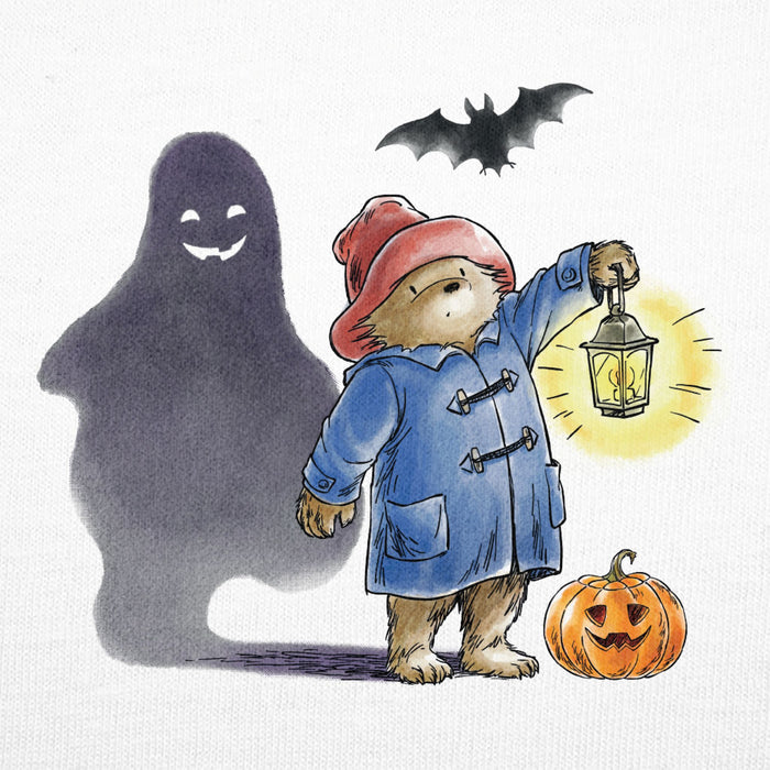 Illustration of paddington bear character in a blue coat with a lantern, ghost, bat, and pumpkin on a white background