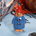 Paddington Bear christmas decoration with red hat and blue coat on a light blue background