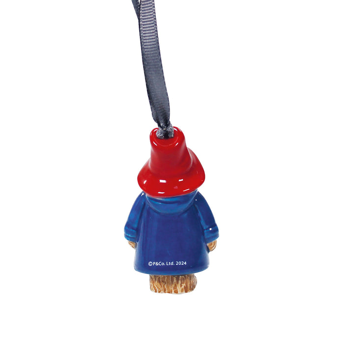 paddington bear christmas decoration with a red top hat and blue body on a white background
