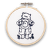 A mini embroidery kit depicting Paddington Bear waving hello, mounted in a hoop.