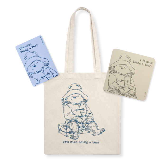 Tote bag with bear illustration and 'It's nice being a bear' text, surrounded by matching items on a white background.
