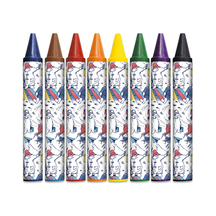 A set of 8 coloured wax crayons for kids with Paggy Fortnum Paddington bear and paper aeroplane illustrations  on the labels, set onto a white background.
