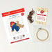 Paddington Cross stitch kit with pattern, thread, and hoop on a light background