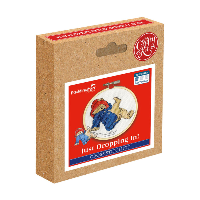 Cross stitch kit packaging with cartoon Paddington character on red background
