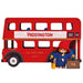 A red double-decker toy bus with Paddington Bear printed on the side, shown on a plain white background. The toy bus includes a small Paddington figure and suitcase at the front.
