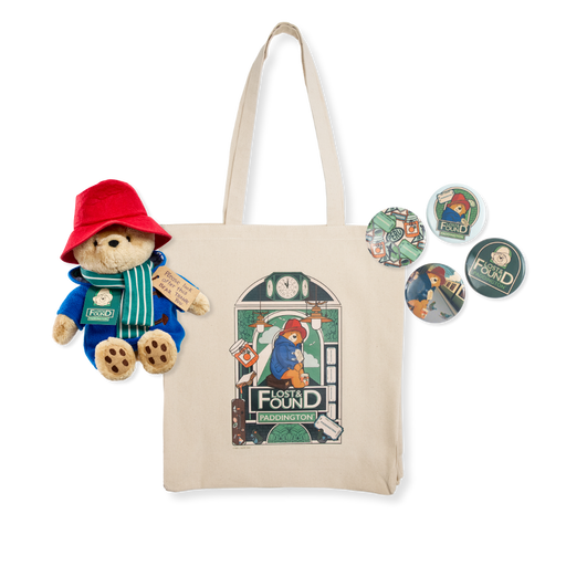 Tote bag with Paddington Bear plush toy and decorative buttons on a white background