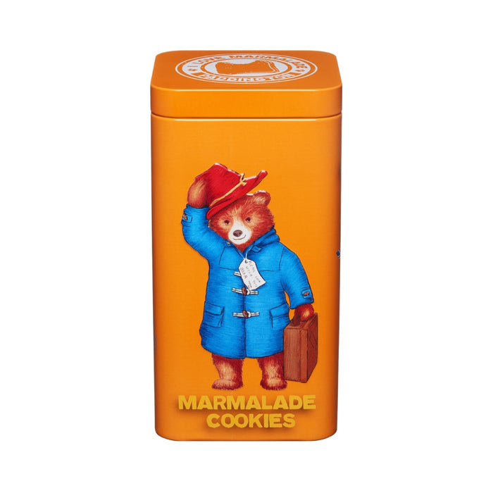 Marmalade cookies with a Paddington Bear-themed orange tin on a white background