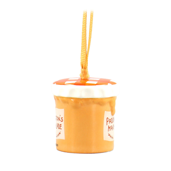 A ceramic hanging Christmas decoration shaped like a jar of marmalade with a 'Paddington's Marmalade' label, complete with a gingham-style lid and a satin ribbon loop.