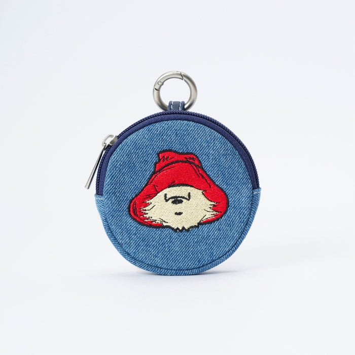 A circular blue denim bubble shaped coin purse featuring an embroidered Paddington bear character with a red hat and cream beard, complete with a silver metal key ring on a white background.