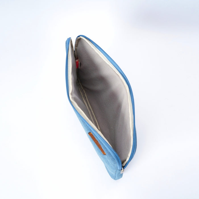 A light blue denim zippered laptop case with a white interior lining, shown open against a clean white background.