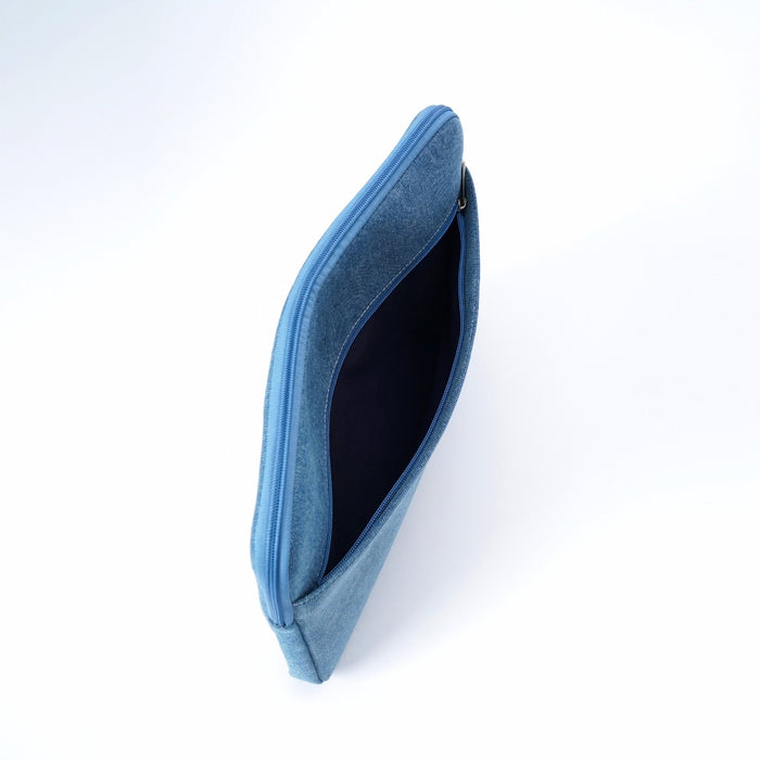 A blue zippered denim iPad sleeve or case shown open from an angled top-down view, revealing a dark navy interior lining, set against a plain white background.